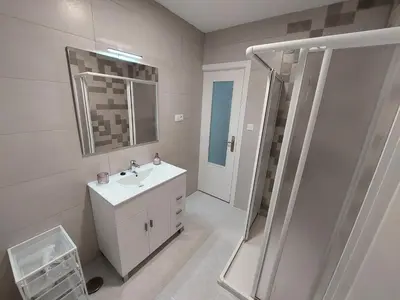 a white bathroom with a sink and a shower at Acea Nova 2 in Monforte de Lemos