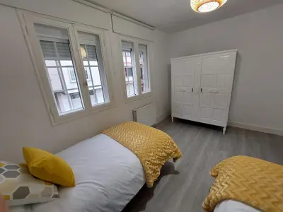 a bedroom with two beds and two windows at Acea Nova 2 in Monforte de Lemos