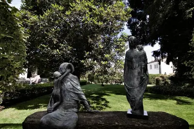 a statue of two women in a park at Hotel Virxe da Cerca by Pousadas de Compostela in Santiago de Compostela