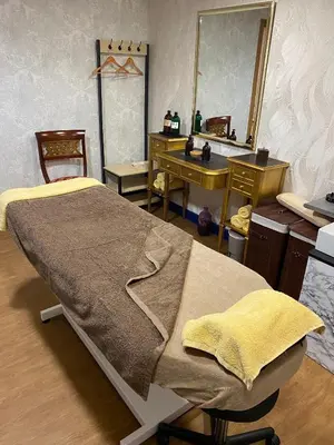 a bedroom with a bed and a vanity and a mirror at Eurostars Araguaney in Santiago de Compostela
