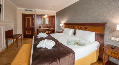 a hotel room with a bed with towels on it at Eurostars Araguaney in Santiago de Compostela