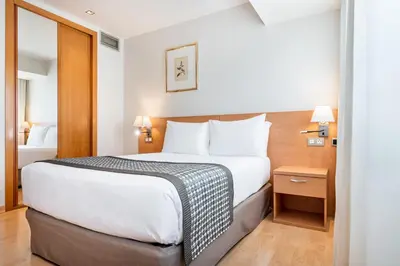 a hotel room with a bed and a television at Dorma Puerta de San Pedro in Lugo