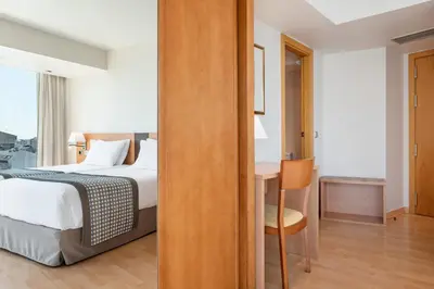 a bedroom with a bed and a desk with a chair at Dorma Puerta de San Pedro in Lugo