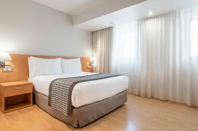 a hotel room with a bed and a window at Dorma Puerta de San Pedro in Lugo