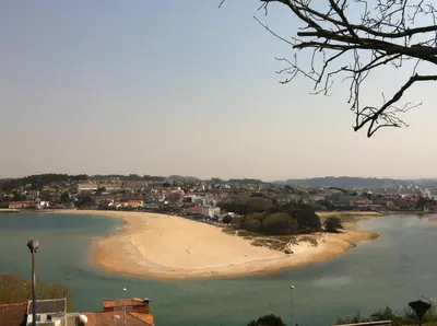 a beach in the middle of a body of water at Hotel Crunia I A Coruña in A Coruña