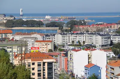 a city with buildings and the ocean in the background at Hotel Crunia I A Coruña in A Coruña
