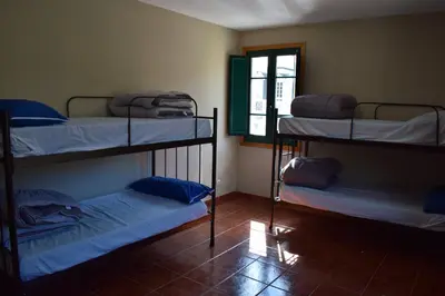 a room with three bunk beds and a window at Tras do convento in Samos