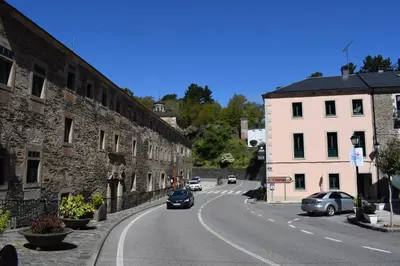 a city street with cars driving down a road at Tras do convento in Samos