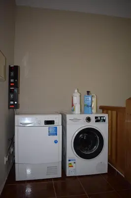 a kitchen with a washing machine and a washer at Tras do convento in Samos