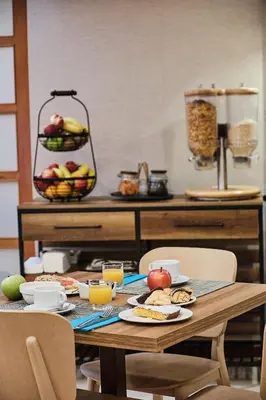 a table with plates of food and fruit on it at Hotel Ciudad de Compostela in Santiago de Compostela