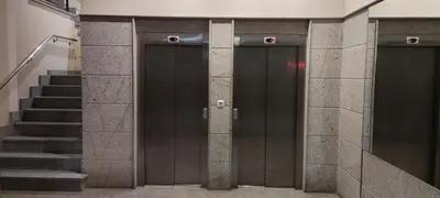 a pair of elevators in a building with stairs at Piso Estación Termal II in Ourense