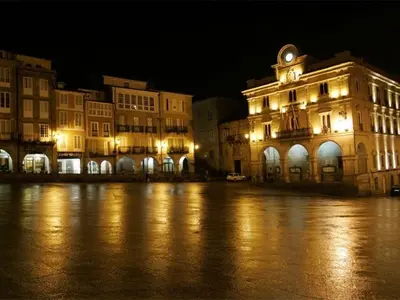 a building with a clock tower on top of it at night at Piso Estación Termal II in Ourense