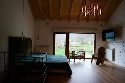 a bedroom with a bed and a large window at El Parreiro VUT-LE-1607 in Villablino