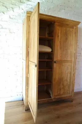 a wooden cupboard with ajar door in a room at El Parreiro VUT-LE-1607 in Villablino