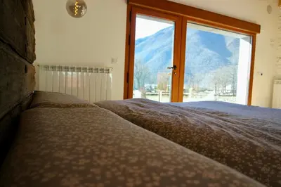 a bedroom with a large window with a mountain view at El Parreiro VUT-LE-1607 in Villablino