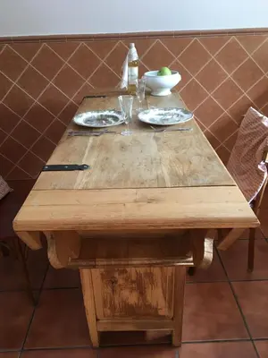 a wooden table with plates of food on it at La Furmumecha in Villablino