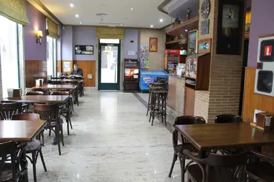 a dining room with tables and chairs in a restaurant at Hotel El Castillo in Ponferrada