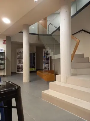 a lobby with stairs and a stair case at LUMEN ALBERGUE in Mondoñedo