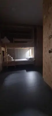 a dark room with two bunk beds in it at LUMEN ALBERGUE in Mondoñedo