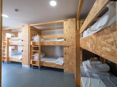 a group of bunk beds in a room at LUMEN ALBERGUE in Mondoñedo