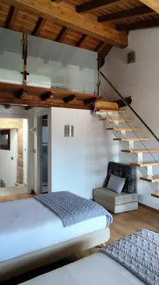 a bedroom with a bed and a staircase at Casa Vilar de Flores in Ourense