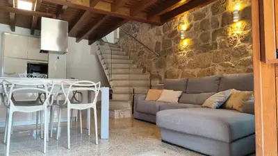 a living room with a couch and a table at Casa Vilar de Flores in Ourense