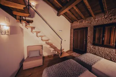 a bedroom with a staircase and a bed and a chair at Casa Vilar de Flores in Ourense