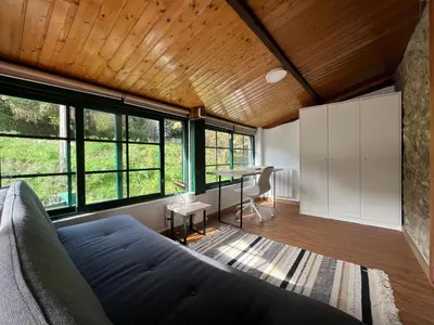 a living room with a couch and a table at Rural Lambre by Miramar Stays in A Coruña