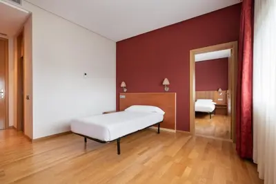 a bedroom with a bed and a mirror at Exe Vía Argentum in Silleda
