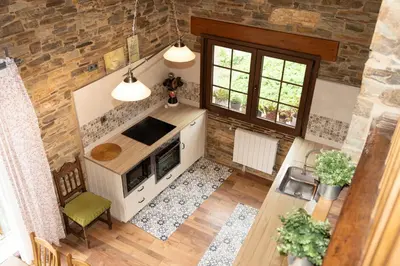 an overhead view of a living room with a fireplace at CASA EL TEIXO in Taramundi