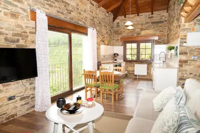 a living room with a couch and a table at CASA EL TEIXO in Taramundi