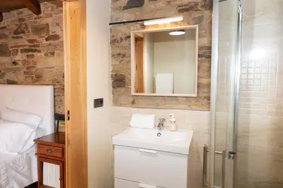 a bathroom with a sink and a shower at CASA EL TEIXO in Taramundi