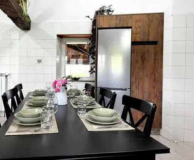 a black table with plates and glasses on it at Casa Mato in Monforte de Lemos