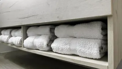 a row of rolls of toilet paper on a shelf at Casa Mato in Monforte de Lemos