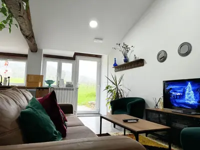 a living room with a couch and a tv at Casa Mato in Monforte de Lemos