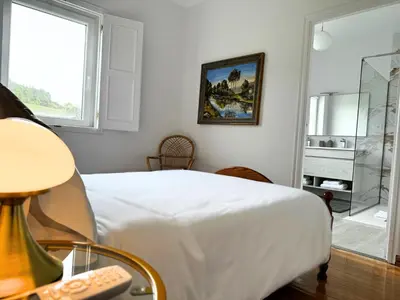 a bedroom with a white bed and a window at Casa Mato in Monforte de Lemos