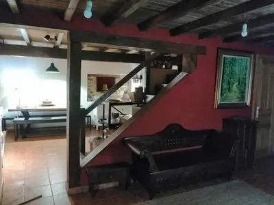 a living room with a staircase with a mirror at Casa de piedra en pequeña aldea de Ortigueira in Nieves