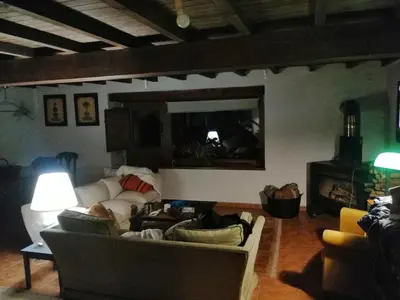 a living room with two couches and a fireplace at Casa de piedra en pequeña aldea de Ortigueira in Nieves