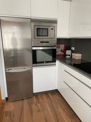 a kitchen with a stainless steel refrigerator and microwave at Apartamento en el centro de Viveiro in Vivero