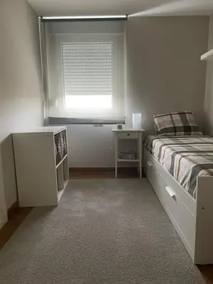 a white bedroom with a bed and a window at Apartamento en el centro de Viveiro in Vivero
