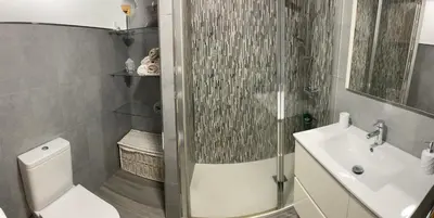 a bathroom with a shower and a toilet and a sink at Apartamento en el centro de Viveiro in Vivero