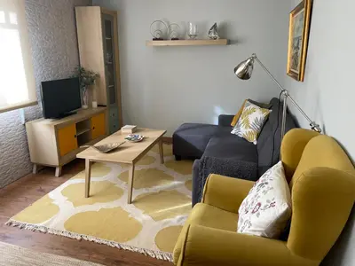 a living room with a couch and a table at Apartamento en el centro de Viveiro in Vivero