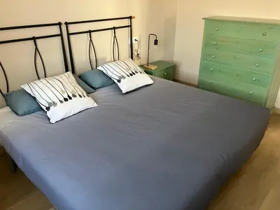 a large blue bed with two pillows and a green dresser at A Casa da Fonte in Santa Eulalia de Oscos