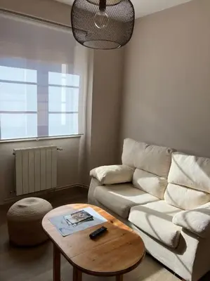 a living room with a couch and a coffee table at A Casa da Fonte in Santa Eulalia de Oscos