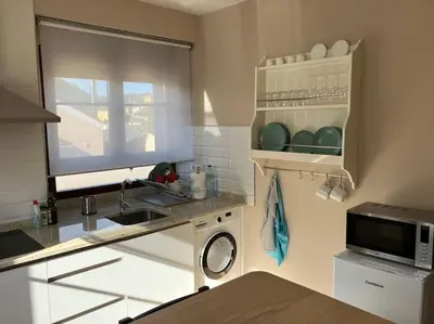 a kitchen with a sink and a microwave at A Casa da Fonte in Santa Eulalia de Oscos