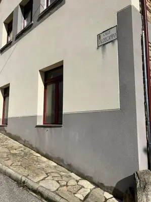 a building with a street sign on the side of it at A Casa da Fonte in Santa Eulalia de Oscos