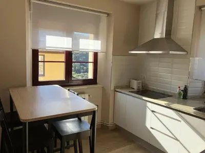 a kitchen with a table and a counter top at A Casa da Fonte in Santa Eulalia de Oscos