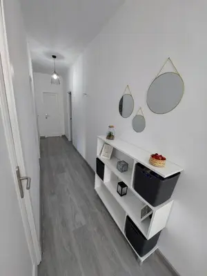 a hallway with white walls and white shelves and mirrors at Acea Nova 1 in Monforte de Lemos