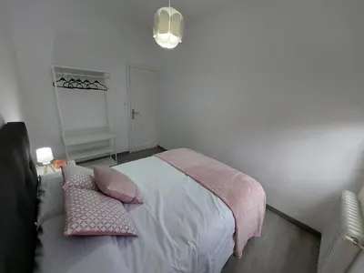 a bedroom with a bed with pink pillows on it at Acea Nova 1 in Monforte de Lemos