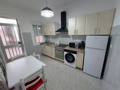 a kitchen with a white refrigerator and a microwave at Acea Nova 1 in Monforte de Lemos